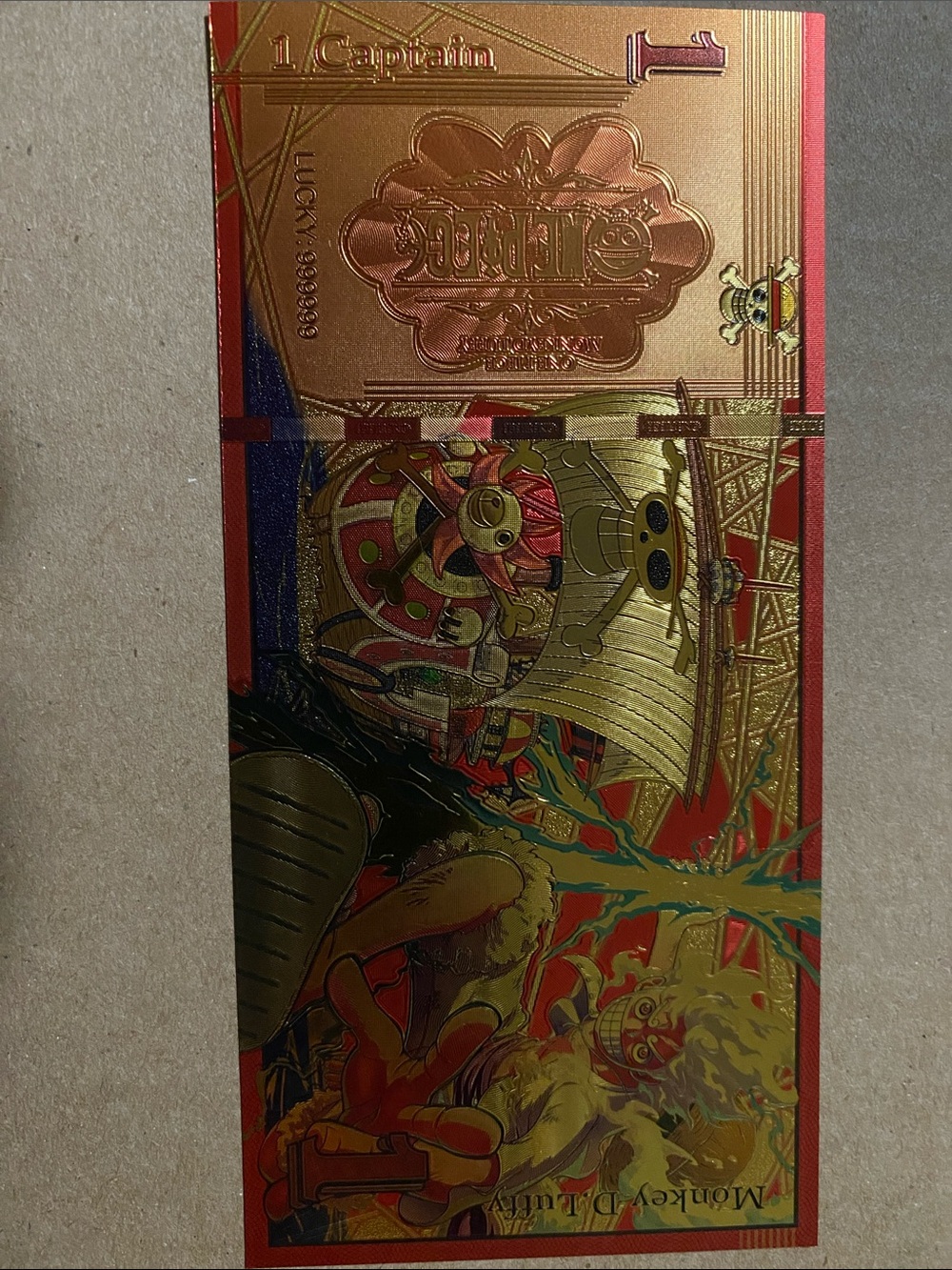 Gold Foil Anime Collectible Card with Red Accents ft Monkey D Luffy
